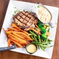 Bone-In Pork Chop (14 Oz) · Incredibly juicy and grilled to perfection. Served with mashed potatoes, seasonal vegetables...