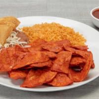 Chilaquiles · Corn tortilla chips smothered in our signature red or green sauce. Served with rice, refried...