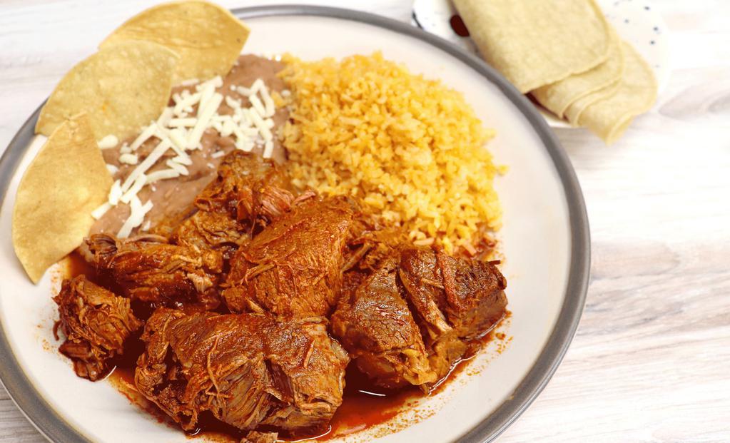 Birria De Res Plate · Beef stew. Served with rice, refried beans, tortillas, onions, cilantro, and lime.