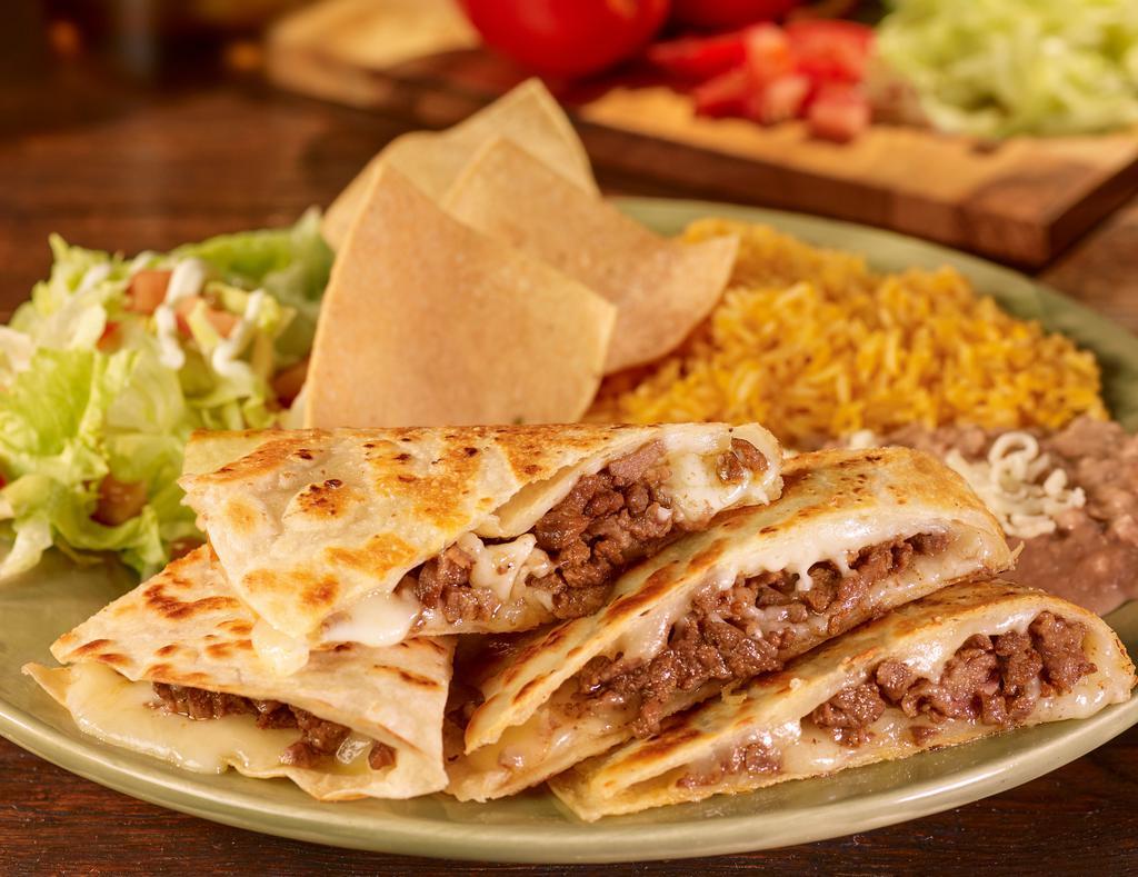 Stuffed Quesadilla Plate · A large flour tortilla filled with cheese and choice of meat. Served with rice and refried beans, lettuce, tomatoes, sour cream, and choice of green or red salsa.