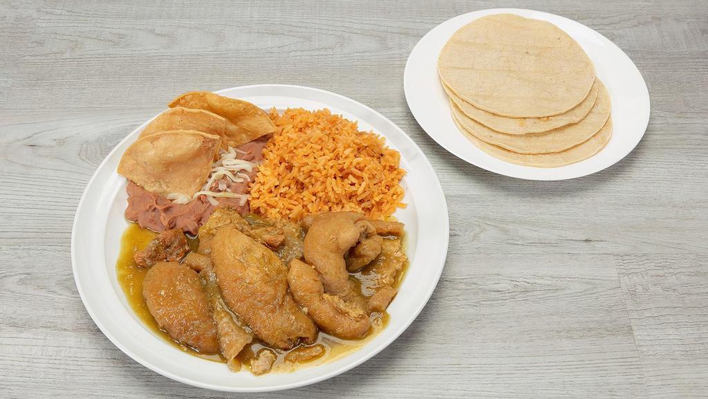 Chicharron En Salsa Verde Plate · Pork cracking cook in spicy green sauce and served with rice, refried beans and corn tortillas.