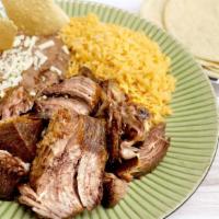 Carnitas Plate · Plato de carnitas. Served with rice, refried beans, tortillas, choice of green or red salsa,...