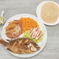 Mojarra Frita Plate · Deep Fried Tilapia served with rice, refried beans, lettuce, tomato, sour cream and corn tor...