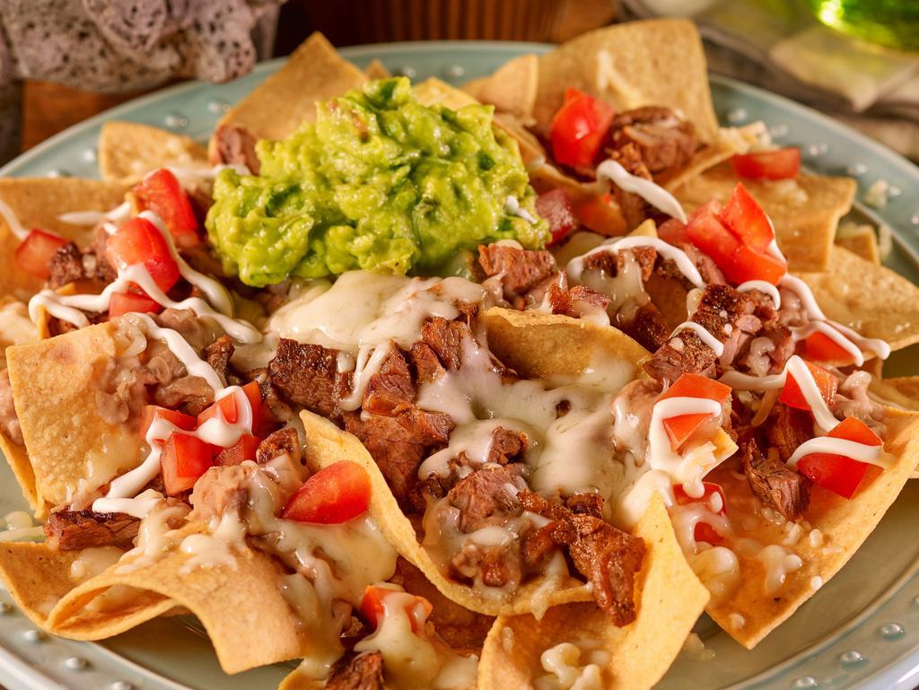 Nachos Al Gusto · Tortilla chips topped with refried beans, cheese, tomatoes, guacamole, sour cream, and choice of meat.