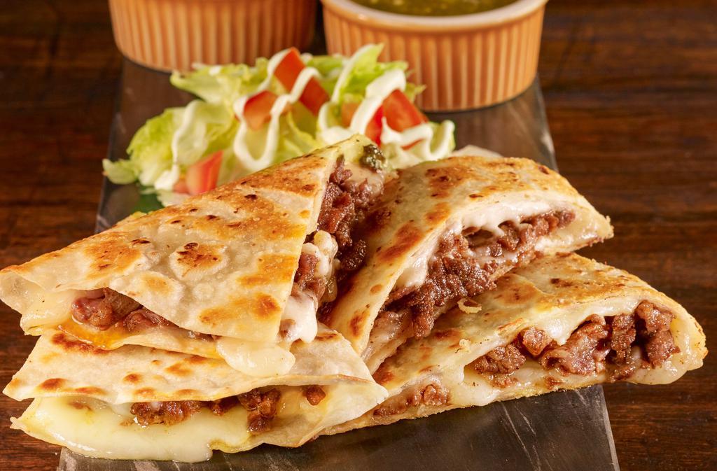 Stuffed Quesadilla · A large flour tortilla stuffed with cheese and choice of meat. Served with lettuce, tomatoes, sour cream, and choice of green or red salsa.