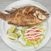 Mojarra Frita · Deep Fried Tilapia served with lettuce, tomato and sour cream.
