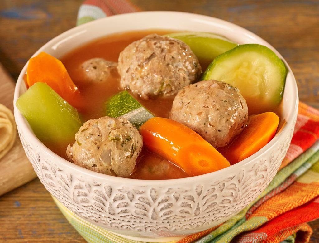 Albondigas De Res · Beef Meatball Soup served with rice, tortillas, cilantro, onions & lime.