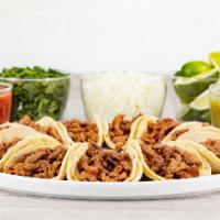 Taquiza Vallarta · 10 street tacos served with choice of meat, green or red salsa, limes, onions, cilantro. Ser...