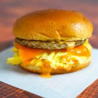 Sausage, Egg And Cheddar Sandwich · 2 fresh cracked cage-free scrambled eggs, melted Cheddar cheese, breakfast sausage, and Srir...