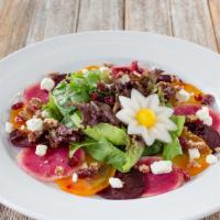Beets Salad · Assorted steamed beets on a bed a mix baby greens topped with crumbled Goat cheese, dry cran...