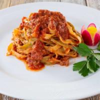 Fettuccine Ragu · Spinach and regular homemade pasta with beef Ragu sauce.