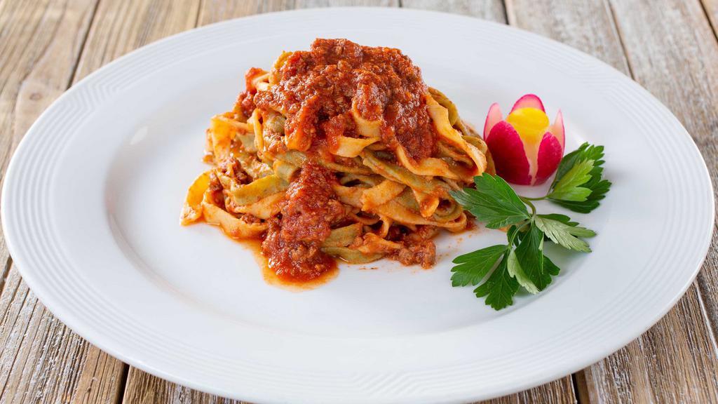 Fettuccine Ragu · Spinach and regular homemade pasta with beef Ragu sauce.