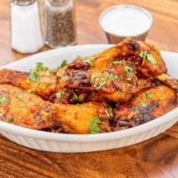 Wings · Crispy bone in wings tossed with your choice of sauce: Buffalo, BBQ,  honey sriracha or sout...