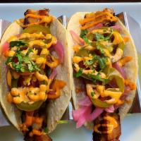 Pork Belly Or Brisket Tacos · Two tacos with pickled red onions, pickled jalapeños and chipotle aioli.