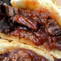 Brisket Sandwich · 16-hour smoked brisket topped with our house BBQ sauce. Served on fresh ciabatta.