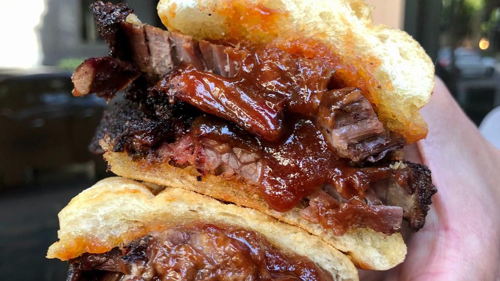 Brisket Sandwich · 16-hour smoked brisket topped with our house BBQ sauce. Served on fresh ciabatta.