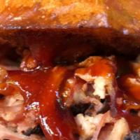 Pulled Pork Sandwich · 16-hour smoked pulled pork topped with our house BBQ sauce. Served on a brioche bun.