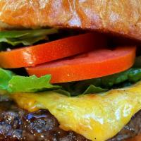Cheeseburger · 1/2 lb. beef patty grilled to order topped lettuce, tomato and Cheddar. Served on a brioche ...