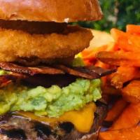 Guac Burger · 1/2 lb. beef patty grilled to order topped with bacon, onion rings, Cheddar cheese and fresh...