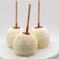 Cheesecake Caramel Apple · Caramel apple dunked in white chocolate and rolled in sugar and graham cracker crumbles.