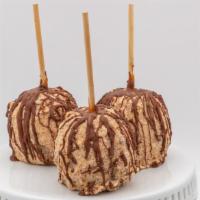 Snickers Caramel Apple · Caramel apple dunked in white chocolate rolled in snickers with a milk chocolate drizzle.