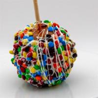 Rainbow M&M Caramel Apple · Caramel apple dunked in white chocolate then rolled in colorful m&ms and finished with a whi...