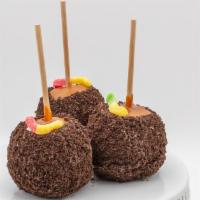 Outrageous Oreo Caramel Apple · Caramel apple dunked in white chocolate, rolled in oreo cookie crumbs, and topped with gummy...