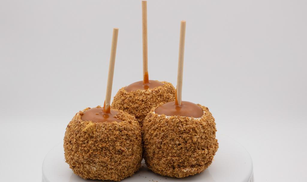 Pecan Pie Caramel Apple · Caramel apple dunked in white chocolate, rolled in a mix of pecans, cinnamon, brown sugar and graham cracker crumbs.