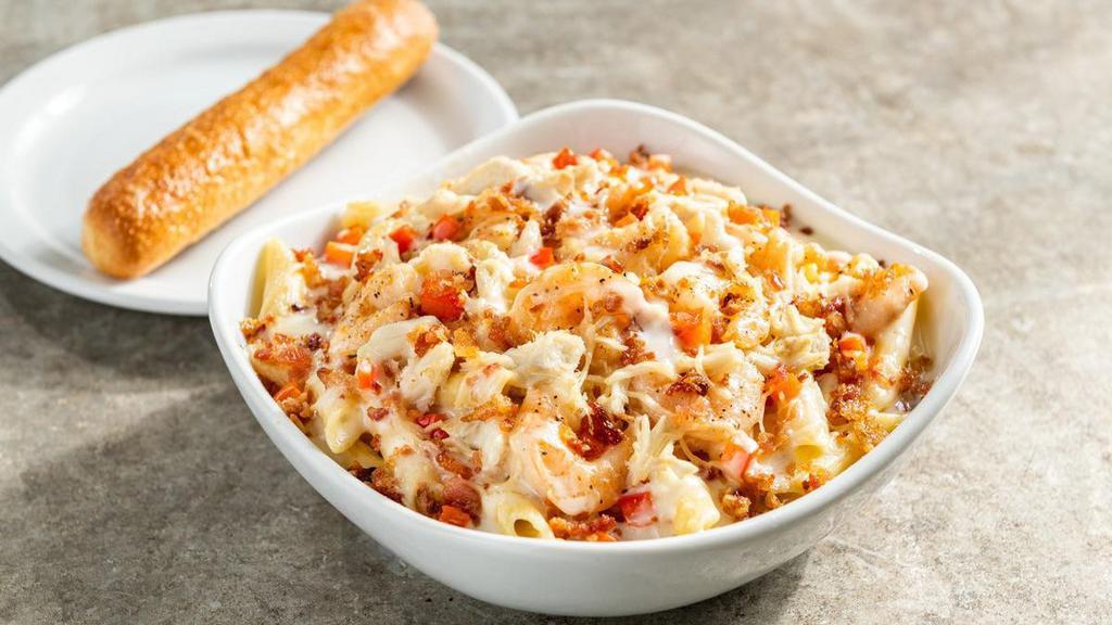 Baked Seafood Pasta · Fresh baked crab, garlic shrimp, diced red bell pepper, bacon over a bed of penne pasta with Alfredo sauce & shredded Parmesan.