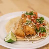 Baja Fish Taco · Ensenada style beer-battered and fried tilapia , served with shredded cabbage and pico de ga...