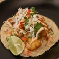 Baja Shrimp Taco · Ensenada style beer-battered and fried shrimp , topped with shredded cabbage and pico de gal...