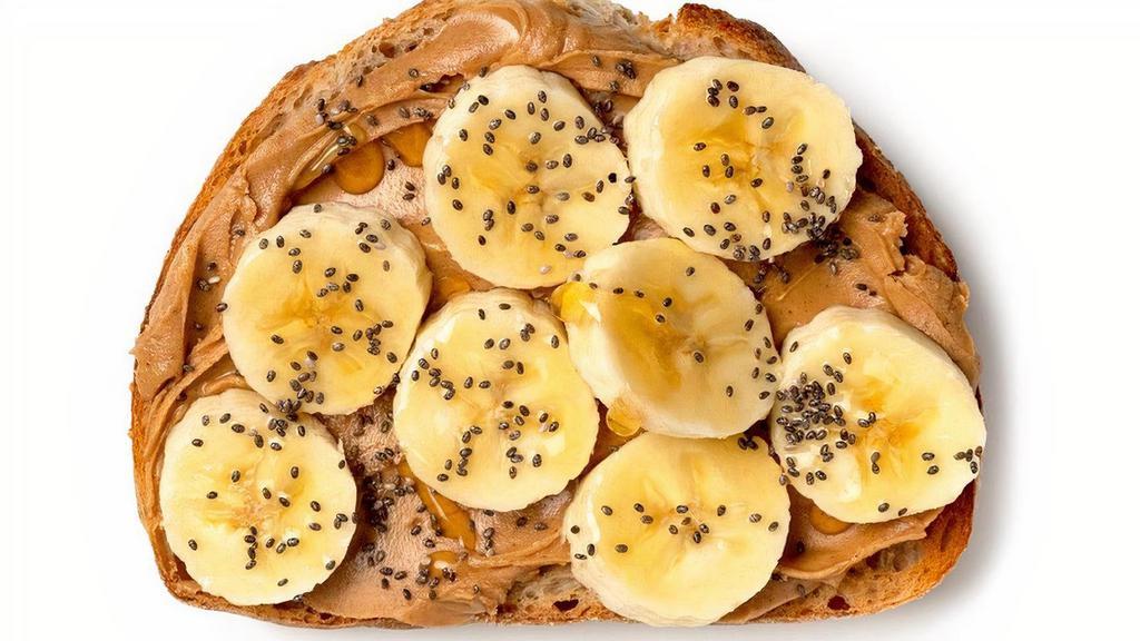 Peanut Butter & Banana Toast · A creamy comfort, featuring smooth peanut butter, fresh sliced banana, a drizzle of pure honey and a scattering of chia seeds all nestled on our crunchy and satisfying sourdough toast.. Peanut Butter, Fresh Banana, Raw Honey, and Chia Seeds