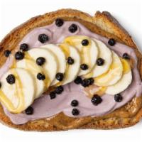 Acai Almond Butter Toast · Savory Almond Butter with a layer of Acai Greek Yogurt topped with sliced Bananas, dried Blu...