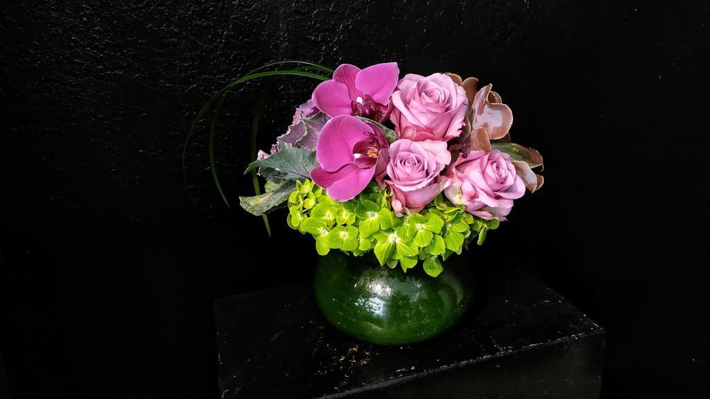 Jane · Designed for those loved ones who will travel to the moon and back to you. Made in all purples and greens, create a shooting star effect with a trail of lily grass that jettisoned this design into being a new favorite. Made in a 5x4 posey vase.