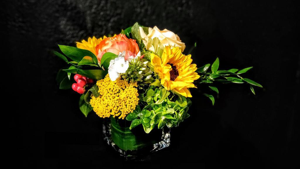 Carmichael · 4x4 cube or cylinder of brightly colored flowers in oranges and yellows in a pavé design (low and compact)