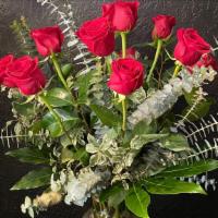 Dozen Roses  · Ye olde dozen red roses in the classic styling with full greenery in a glass vase. Color opt...
