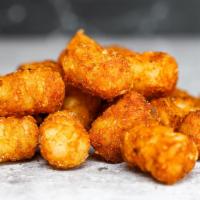 Side Of Spiced Tots · Crispy potato tots tossed in a medium heat spiced Nashville seasoning blend. Served with a s...