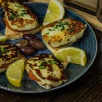 Hallumi · Sliced Cyprus cheese grilled to perfection and topped with sliced tomato.  Served with pita ...