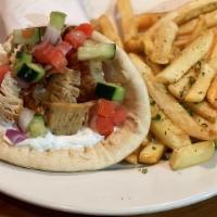 Chicken Gyro Sandwich · Shaved chicken cooked on a spit, topped with tzantziki, fresh tomatoes, red onion, and cucum...