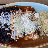 Enchiladas Mexico City · Two hand pulled chicken enchiladas topped with tomatillo sauce, melted Oaxaca cheese, crema,...