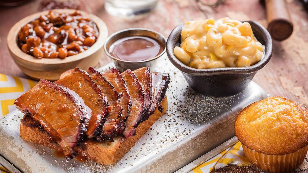 Texas Beef Brisket Platter · Our classic Texas Beef Brisket is rubbed with a blend of Dave's secret spices, coarse black pepper and a hint of brown sugar, then slow-smoked over hickory until it's juicy and tender. Served with choice of two sides and a Corn Bread Muffin.