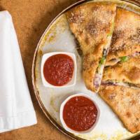 Specialty Calzone · Stuffed & baked w/ your favorite pizza toppings. Served with side of fresh made marinara sau...