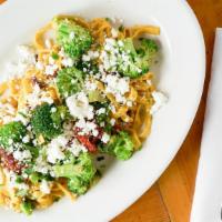 Goat Cheese Fettuccine · Lemon pepper fettuccine, sundried tomatoes and broccoli tossed in olive oil and garlic and t...