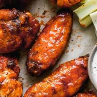 Bone-In Chicken Wings · Bone-in chicken wings with sauce. Served with celery or carrots, and blue cheese or ranch.