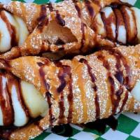 Cannoli · Crispy pastry shell, filled with a sweetened ricotta cheese with chocolate chips, topped wit...