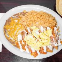 Chilaquiles · Sautéed tortillas simmered in red sauce, two eggs on top and sour cream with rice and beans.