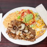 Carne Asada Plate · Steak with grilled onions, rice, beans, salad and tortillas.