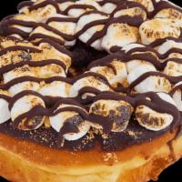 S'Mores Raised · Chocolate iced donut with mini marshmallows. Topped with a chocolate drizzle and graham crac...