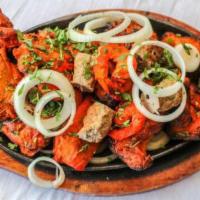 Tandoori Mix Grill · Combination of tandoori chicken, chicken tikka, lamb tikka, and fish tikka.