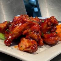 The District Traditional Wings · Bone-in chicken wings tossed in our own District wing sauces served with celery and carrots....